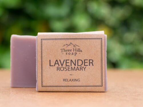 Lavender Rosemary soap bar with rustic label on light surface and green outdoor background