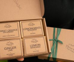 Soap gift set with four citrus-scented bars and green ribbon in kraft box