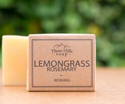 Lemongrass rosemary soap bar with kraft paper label on wooden surface
