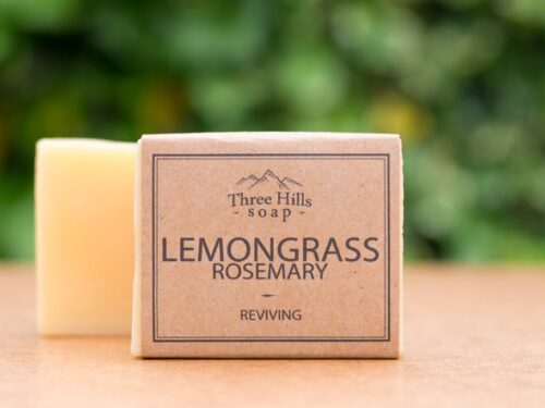 Lemongrass rosemary soap bar with kraft paper label on wooden surface