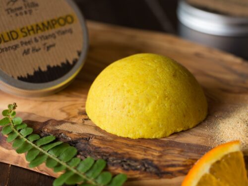 Solid Shampoo bar for all hair types on the wooden surface with a black background