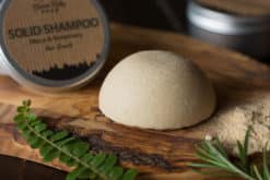 Solid Shampoo bar for all hair types on the wooden surface with a black background