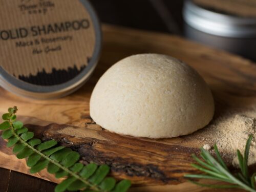Solid Shampoo bar for all hair types on the wooden surface with a black background