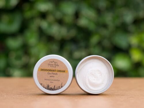 Deodorant Cream Go Fresh rustic label on light surface and green outdoor background