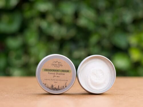 Deodorant Cream for men with rustic label on light surface and green outdoor background