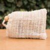 Natural sisal soap bag with a wooden bead, ideal for storing and exfoliating with shampoo bars or soap, promoting lather and extending the life of the bar.