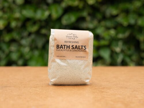 Refreshing bath salts with eucalyptus and lemongrass on wood with green background