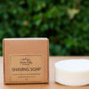 shaving soap in the brown box with a green background