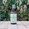 Three Hills Soap Organic Argan Moroccan Oil in 100ml amber glass bottle with pump, displayed on wooden table outdoors