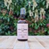 Three Hills Soap Organic Sweet Almond Oil in 100ml amber bottle with pump, sitting on wood with green background