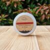 A travel shampoo bar for dandruff in the tin on the wooden surface.