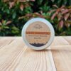 A travel shampoo bar for normal hair in the tin on the wooden surface.