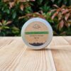 A travel shampoo bar for oily hair in the tin on the wooden surface.